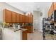 Kitchen with tiled floor, granite countertop, wood cabinets, stainless steel appliances and lots of counter space at 11225 Godwit Ct, New Port Richey, FL 34654