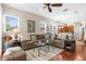Cozy living area with couch, lots of pillows, ceiling fan, and an opening to the adjacent kitchen at 11225 Godwit Ct, New Port Richey, FL 34654