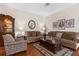Cozy living room featuring comfortable seating, lamps, and a decorative display case at 11225 Godwit Ct, New Port Richey, FL 34654