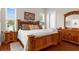 Well-lit main bedroom featuring a stylish headboard, wood floors, and ample space for relaxation at 11225 Godwit Ct, New Port Richey, FL 34654