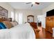 Comfortable main bedroom with an en-suite bathroom, white linens, and access to the outdoors at 11225 Godwit Ct, New Port Richey, FL 34654