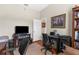 Comfortable office space with a ceiling fan, hardwood floors, and a dark desk, perfect for a productive work environment at 11225 Godwit Ct, New Port Richey, FL 34654