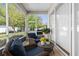 Comfortable screened patio with stylish wicker furniture and views of the well-manicured backyard at 11225 Godwit Ct, New Port Richey, FL 34654