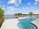 Backyard pool and dock overlooking the water, with outdoor seating at 11549 48Th Ave N, St Petersburg, FL 33708
