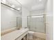 Bright bathroom with decorative glass shower door, granite countertop, and modern lighting fixture at 11549 48Th Ave N, St Petersburg, FL 33708