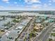 Aerial shot showcases a vibrant commercial district along the water with colorful buildings, parking, and boat access at 11549 48Th Ave N, St Petersburg, FL 33708