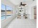 Bright dining room with tile floors, modern table, and large windows with water view at 11549 48Th Ave N, St Petersburg, FL 33708