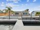 Stunning waterfront property with a backyard pool, private dock, and lush landscaping, creating a perfect oasis for relaxation and entertainment at 11549 48Th Ave N, St Petersburg, FL 33708