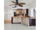 Open-concept kitchen with breakfast bar, wine rack, tile floors, and updated lighting fixtures at 11549 48Th Ave N, St Petersburg, FL 33708