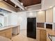 Well-lit kitchen with wooden cabinets, tile floors, modern appliances, and a butcher block countertop at 11549 48Th Ave N, St Petersburg, FL 33708