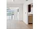 Spacious living area featuring tile floors and white walls that lead to the kitchen and rear of the house at 11549 48Th Ave N, St Petersburg, FL 33708