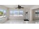 Bright living room with tile flooring, views of waterway, and access to the outdoor area at 11549 48Th Ave N, St Petersburg, FL 33708