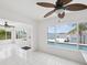 Bright room features a tiled floor, a ceiling fan, and an access door, offering a seamless transition to outdoor spaces at 11549 48Th Ave N, St Petersburg, FL 33708