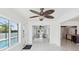 Open living area with tile floors, ceiling fan, and views of the pool and waterway at 11549 48Th Ave N, St Petersburg, FL 33708