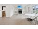 Bright, open living room with tile flooring, a modern fireplace, and abundant natural light from large windows at 11549 48Th Ave N, St Petersburg, FL 33708