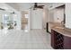 Bright open floor plan with tile flooring, a ceiling fan and views of the dining room and bar at 11549 48Th Ave N, St Petersburg, FL 33708