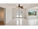 Spacious living room with tile flooring, ceiling fan, and large windows offering plenty of natural light at 11549 48Th Ave N, St Petersburg, FL 33708