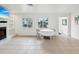 Cozy living room with tile flooring, decorative fireplace, a flat screen television, and natural light at 11549 48Th Ave N, St Petersburg, FL 33708