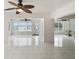 Bright living room with tile flooring, ceiling fans, and water views from large windows at 11549 48Th Ave N, St Petersburg, FL 33708