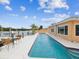Waterfront home with lap pool, private dock, and outdoor seating area at 11549 48Th Ave N, St Petersburg, FL 33708