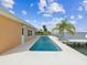 Backyard pool features a private dock, canal access, and a concrete patio perfect for outdoor enjoyment and waterfront living at 11549 48Th Ave N, St Petersburg, FL 33708