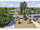 Aerial view of the property showcasing the home, driveway, and surrounding trees at 1165 63Rd S Ave, St Petersburg, FL 33705