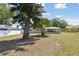 The backyard of the home features a covered patio and mature trees at 1165 63Rd S Ave, St Petersburg, FL 33705