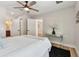 Light-filled bedroom features a modern ceiling fan, ensuite bathroom, and neutral color scheme at 1165 63Rd S Ave, St Petersburg, FL 33705