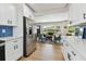 Open kitchen with stainless steel refrigerator and views into the living room at 1165 63Rd S Ave, St Petersburg, FL 33705