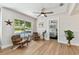 Cozy living room with hardwood floors, a ceiling fan, and a view into the bedroom, creating a comfortable and inviting space at 1165 63Rd S Ave, St Petersburg, FL 33705