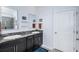 Elegant bathroom featuring dual sinks with granite counters, dark cabinets, and modern fixtures at 12315 Dora Trail, Parrish, FL 34219