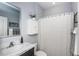 Cozy bathroom with white marbled countertop vanity, cabinet and striped curtain at 12315 Dora Trail, Parrish, FL 34219
