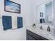 Stylish powder room with a modern vanity, marble countertop, and elegant mirror at 12315 Dora Trail, Parrish, FL 34219