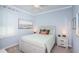 Relaxing bedroom featuring soft blue walls, a plush bed, and charming décor at 12315 Dora Trail, Parrish, FL 34219