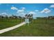 A dog park within a community, featuring a grassy area, trees, and amenities for pets and their owners at 12315 Dora Trail, Parrish, FL 34219