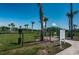 A fenced dog park with grassy areas, trees, and amenities for pet owners and their furry friends at 12315 Dora Trail, Parrish, FL 34219
