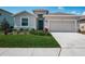 Charming single-Gathering home boasts lush landscaping, a two-car garage, and a covered entryway at 12315 Dora Trail, Parrish, FL 34219