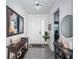 Inviting home foyer featuring grey tiled flooring, an art collection, and warm decor at 12315 Dora Trail, Parrish, FL 34219