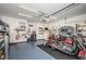 Well-lit garage with epoxy flooring, featuring ample storage and workspace for hobbies and projects at 12315 Dora Trail, Parrish, FL 34219