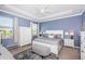 Serene bedroom with a tray ceiling, soft lighting, and picturesque views of the outdoors at 12315 Dora Trail, Parrish, FL 34219