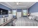 Beautiful main bedroom with tray ceilings, large windows, TV, and en-suite bath at 12315 Dora Trail, Parrish, FL 34219