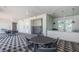 Outdoor patio featuring stylish black-and-white tiled flooring, tables, chairs, grill, and prep area at 12315 Dora Trail, Parrish, FL 34219