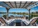 Relax on the patio with a pergola, offering serene lake views and a cozy seating area at 12315 Dora Trail, Parrish, FL 34219