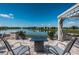 Beautiful patio featuring a modern fire pit, comfortable seating, and serene lake views at 12315 Dora Trail, Parrish, FL 34219