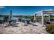 Stunning patio area overlooking a scenic lake, complete with comfortable seating and lush landscaping at 12315 Dora Trail, Parrish, FL 34219