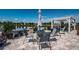 Enjoy outdoor living with this patio set overlooking a serene lake and manicured landscaping at 12315 Dora Trail, Parrish, FL 34219