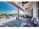 Inviting outdoor patio features ceiling fans, barbecue, and lake views at 12315 Dora Trail, Parrish, FL 34219