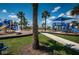 A well-maintained playground with slides, swings, and play structures surrounded by lush landscaping at 12315 Dora Trail, Parrish, FL 34219