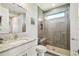Bathroom featuring a single vanity with granite countertops and a glass-enclosed shower with a bench at 12409 Gentle Swan Pl, Odessa, FL 33556