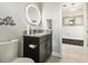 Stylish bathroom with granite countertop, modern fixtures, and decorative mirror at 12409 Gentle Swan Pl, Odessa, FL 33556